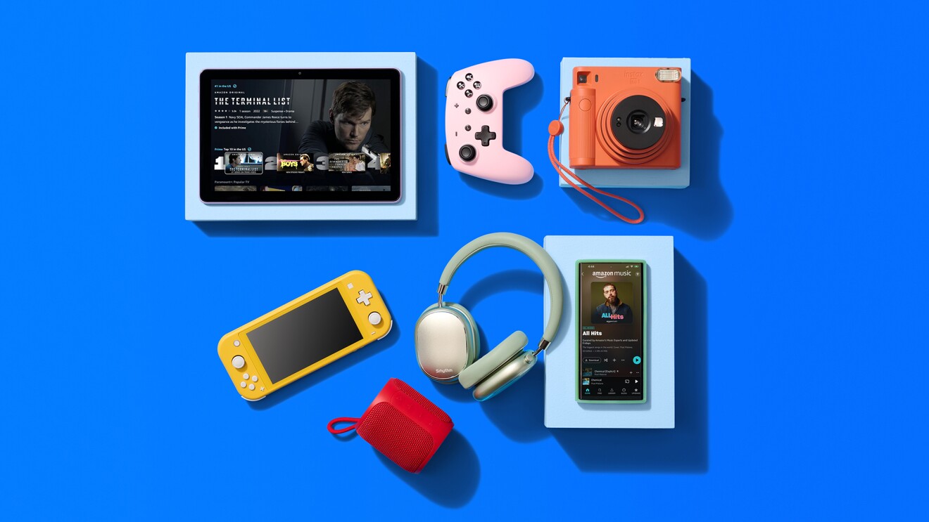 Modern tech gadgets arranged on blue background