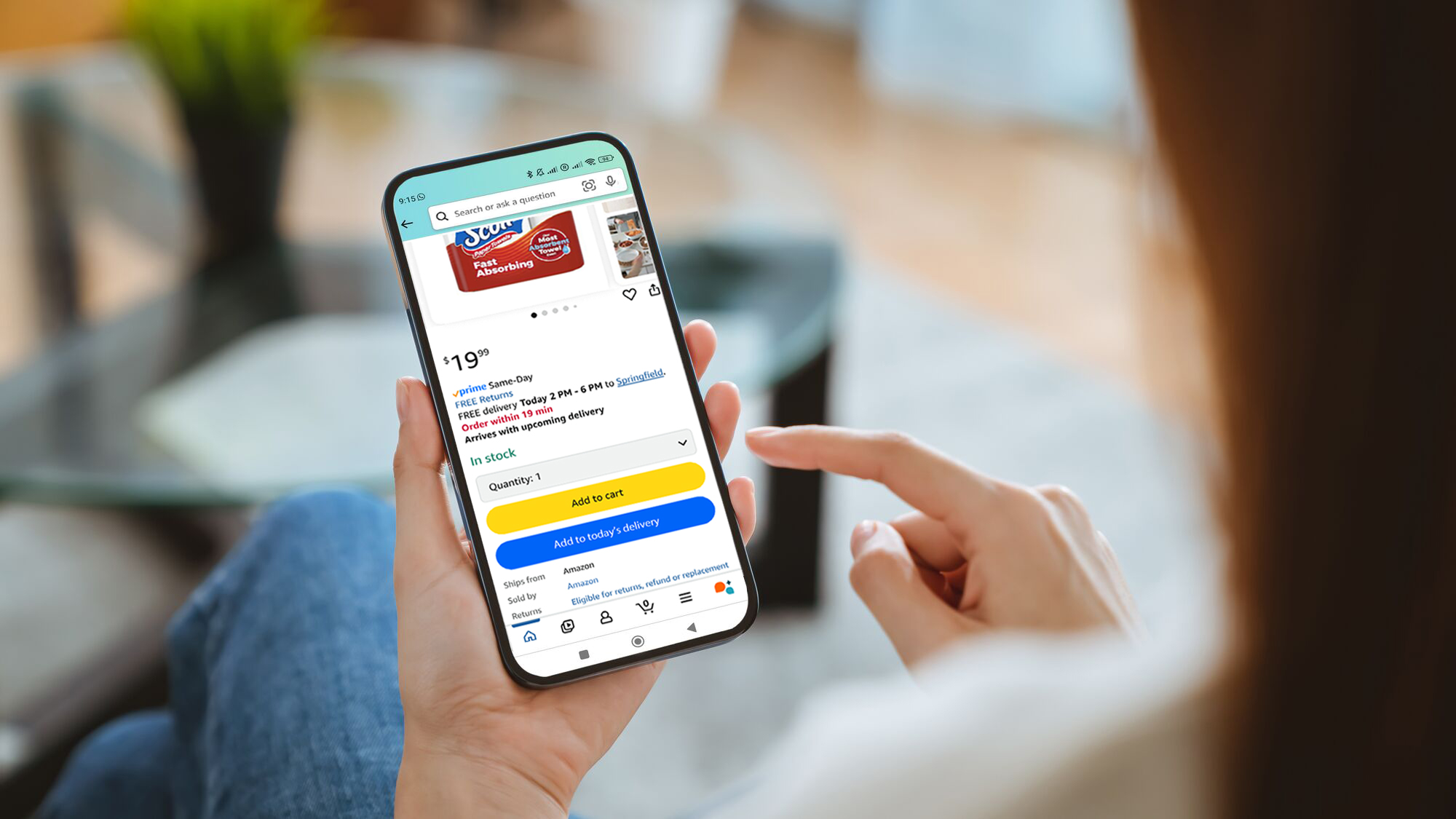 Hands holding smartphone displaying Amazon online shopping app with Add to today's delivery feature