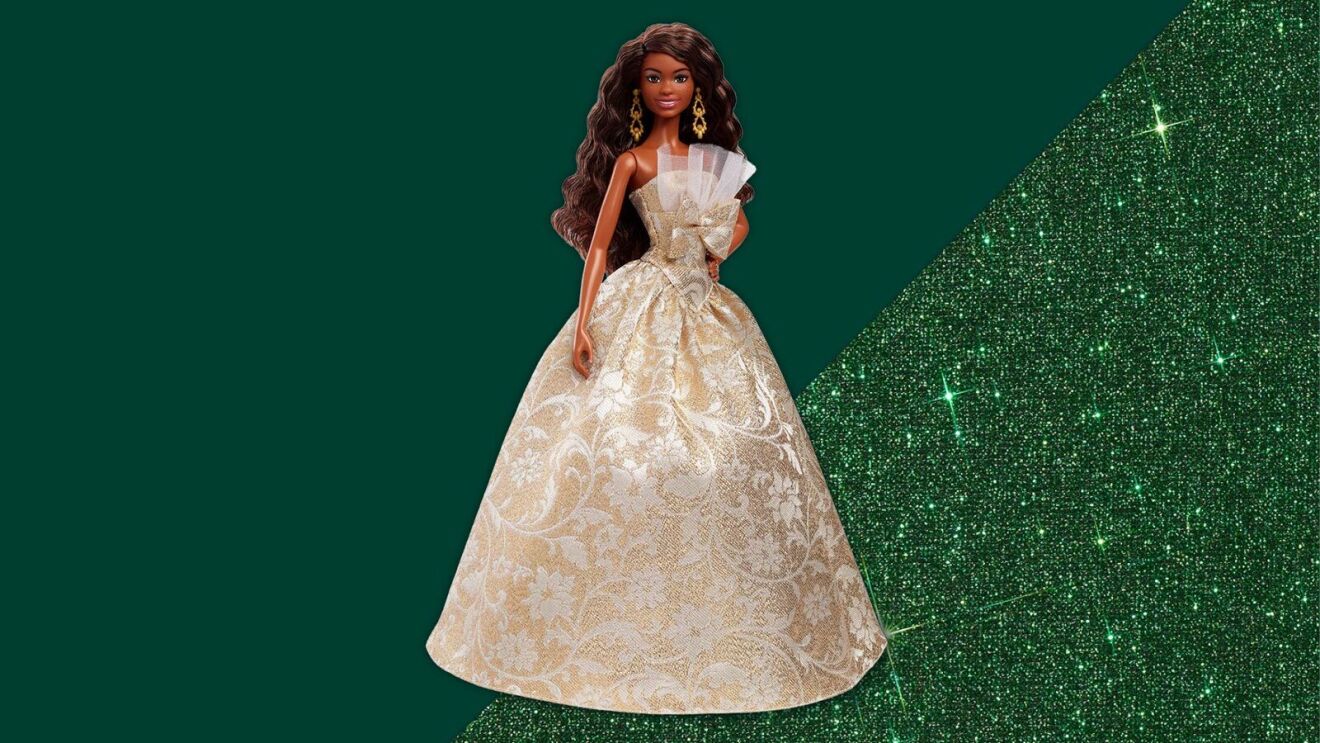 Holiday edition doll wearing luxurious cream-colored gown with floral design